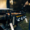 Person grilling using griddle tools