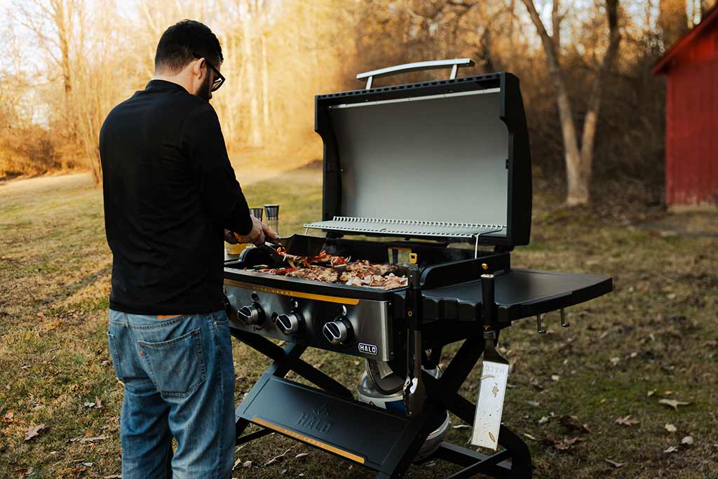 Man cooking at a griddle outside