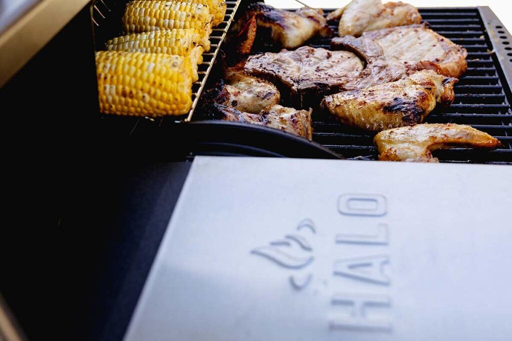 HALO Products Group pellet grill cooking corn on the cob and chicken