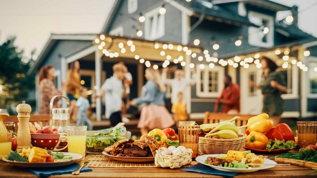 A full barbecue spread on an outdoor dinner table.